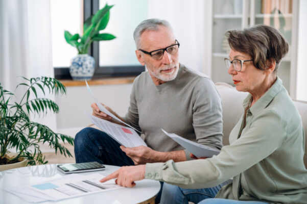 mature couple calculate expenses and planning monthly budget
